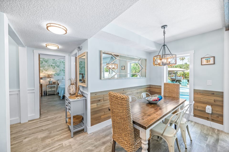 Indoor dining and peek into first floor king bedroom. 