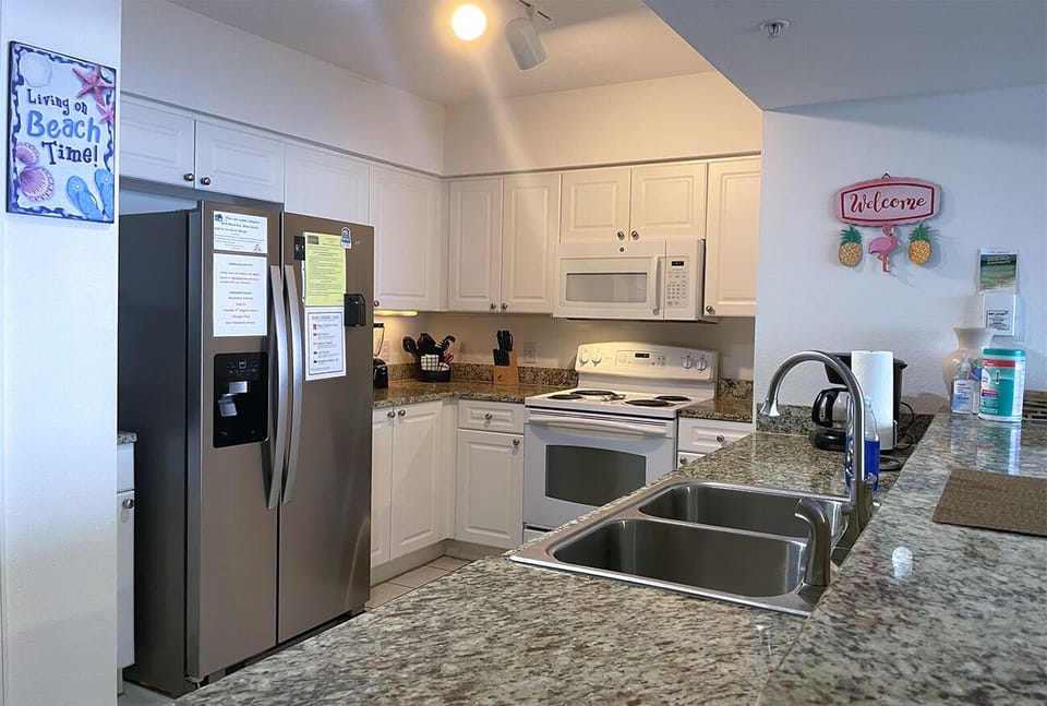 Full kitchen with a refrigerator and a dishwasher purchased in Spring 2022