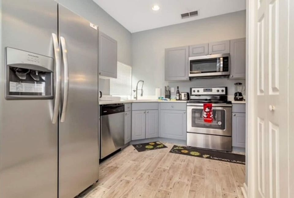 Fully stock kitchens with stainless steel appliances.