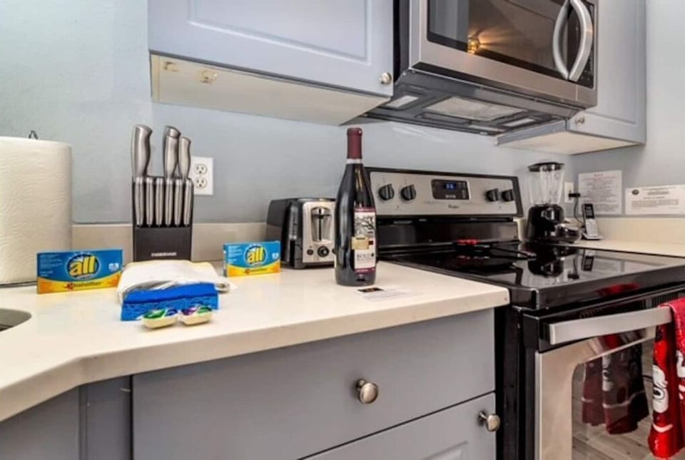 Fully stock kitchens with stainless steel appliances.