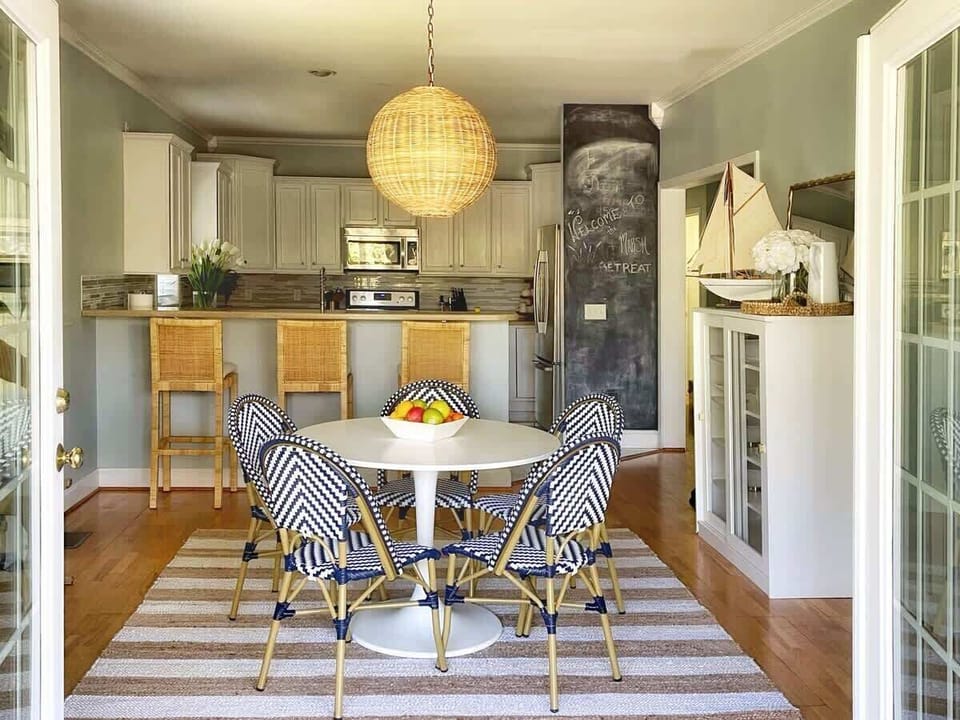 The dining room opens onto a covered porch, allowing for lots of natural lighting. 