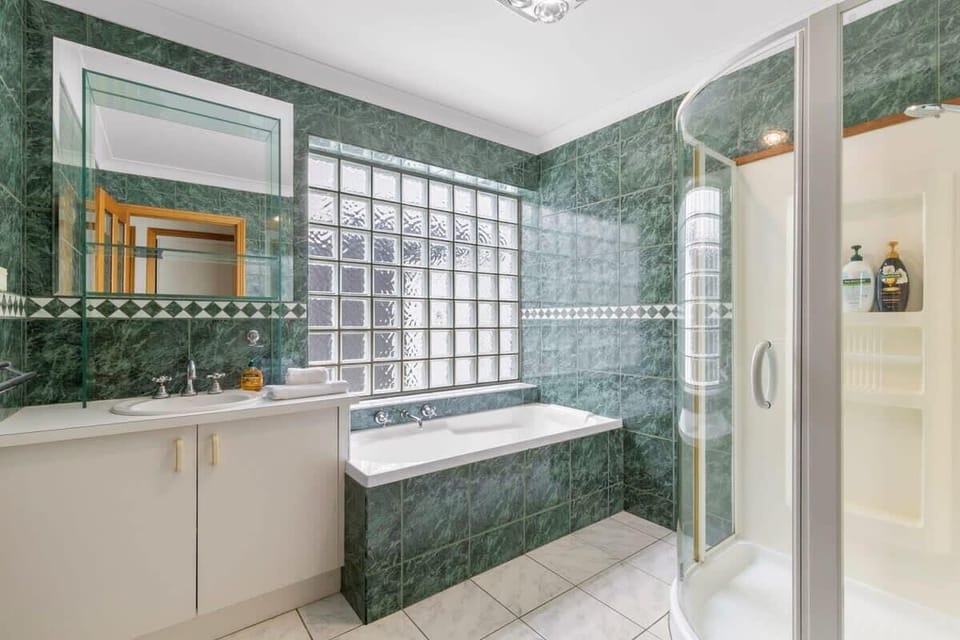 Downstairs, two additional bathrooms with showers (and one bathtub) ensure convenience for all guests. There are three separate toilets in this home.