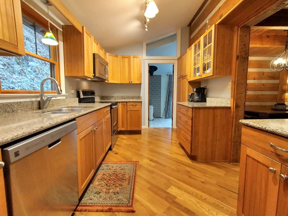 The fully stocked modern kitchen includes a dishwasher and granite counters.