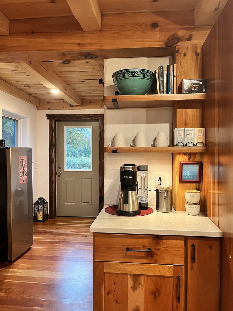 Coffee station with coffee provided, extra fridge, & door to back yard.