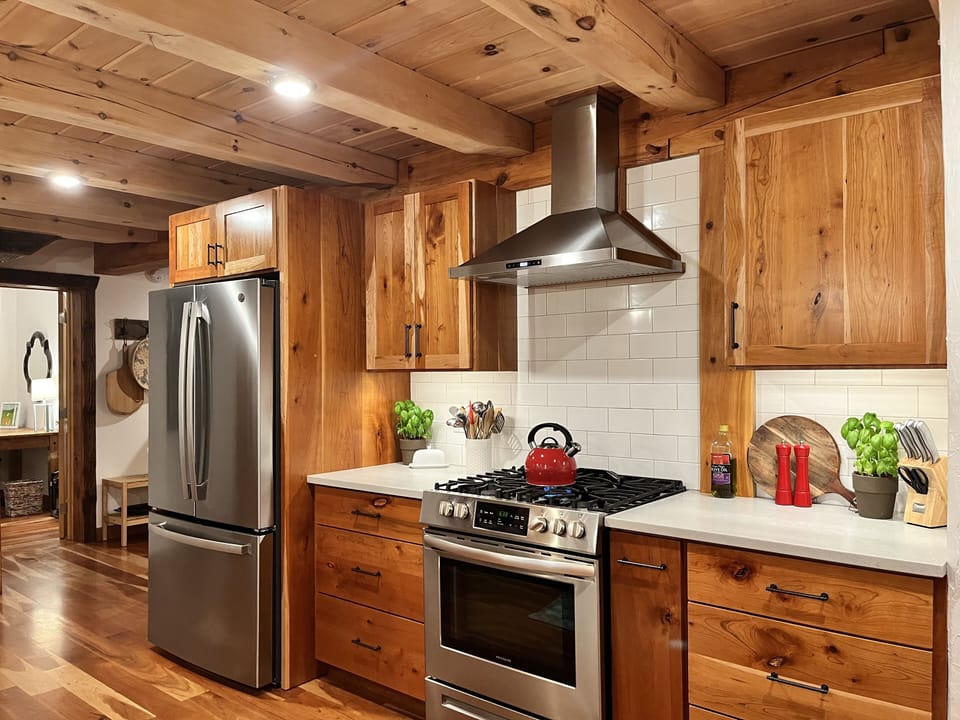 Custom kitchen is fully stocked for all your cooking needs.