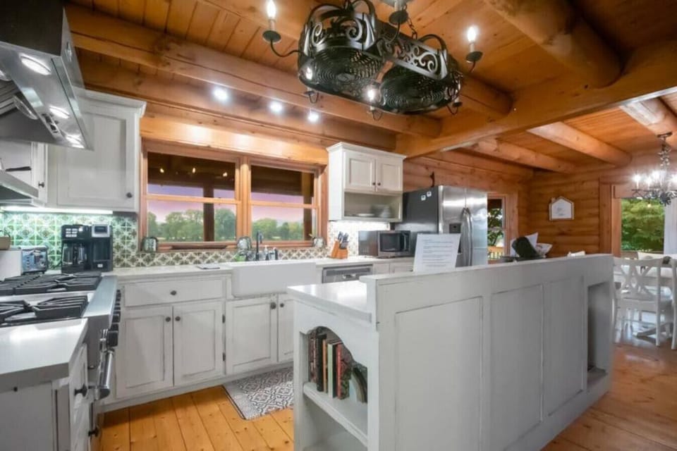 Kitchen has a farmhouse sink and island