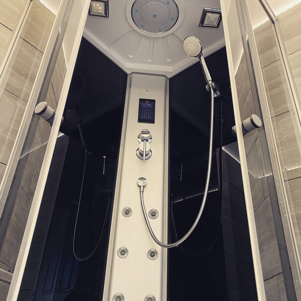 Pod shower ,with built in radio ,body massage jets,and rainfall shower 