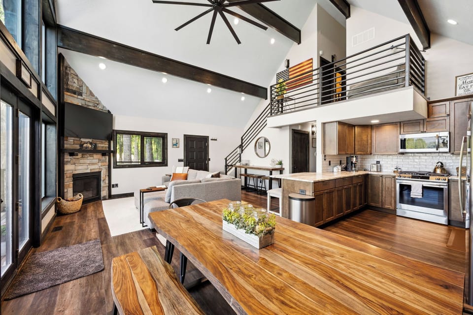 Step into your spacious retreat with soaring ceilings, warm wood tones, and natural light streaming through floor-to-ceiling windows. The open layout invites relaxation and connection.
