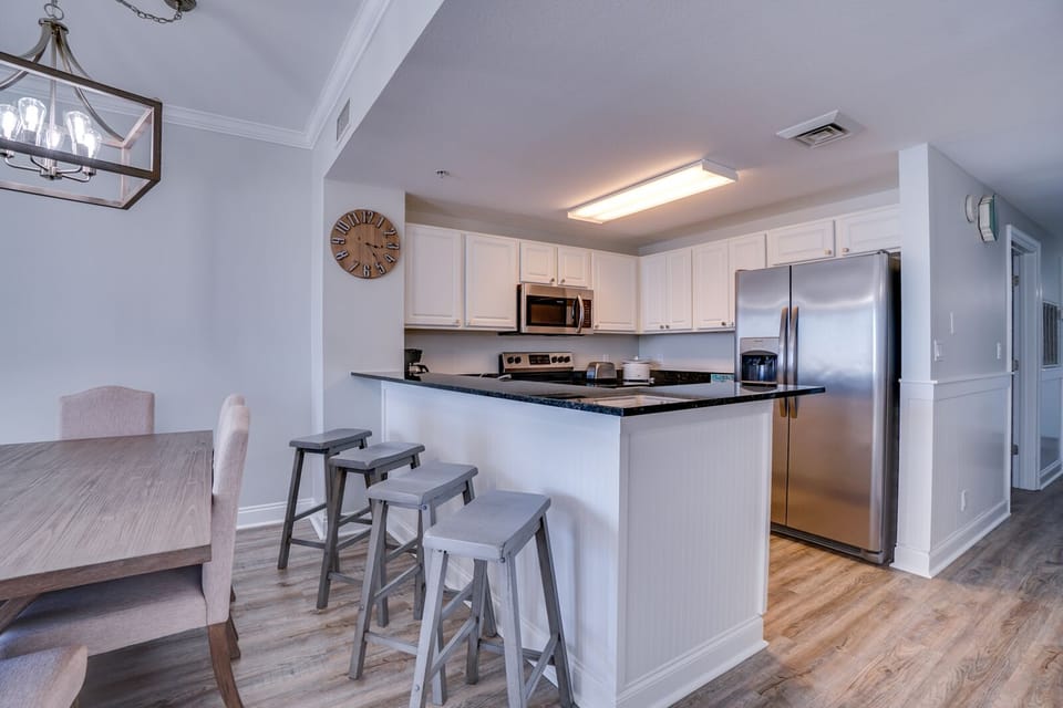 Your spacious kitchen features granite countertops, stainless steel appliances, and a breakfast bar where you can enjoy morning coffee or casual meals together.