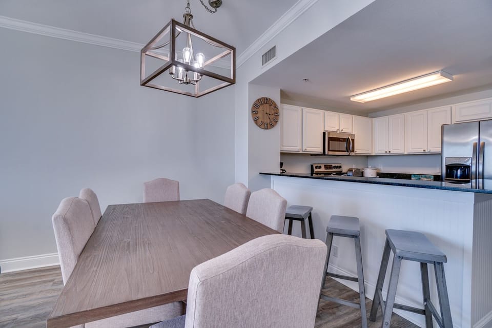 Your open-concept dining and kitchen space features modern comforts with stylish pendant lighting and bar seating for memorable meals.