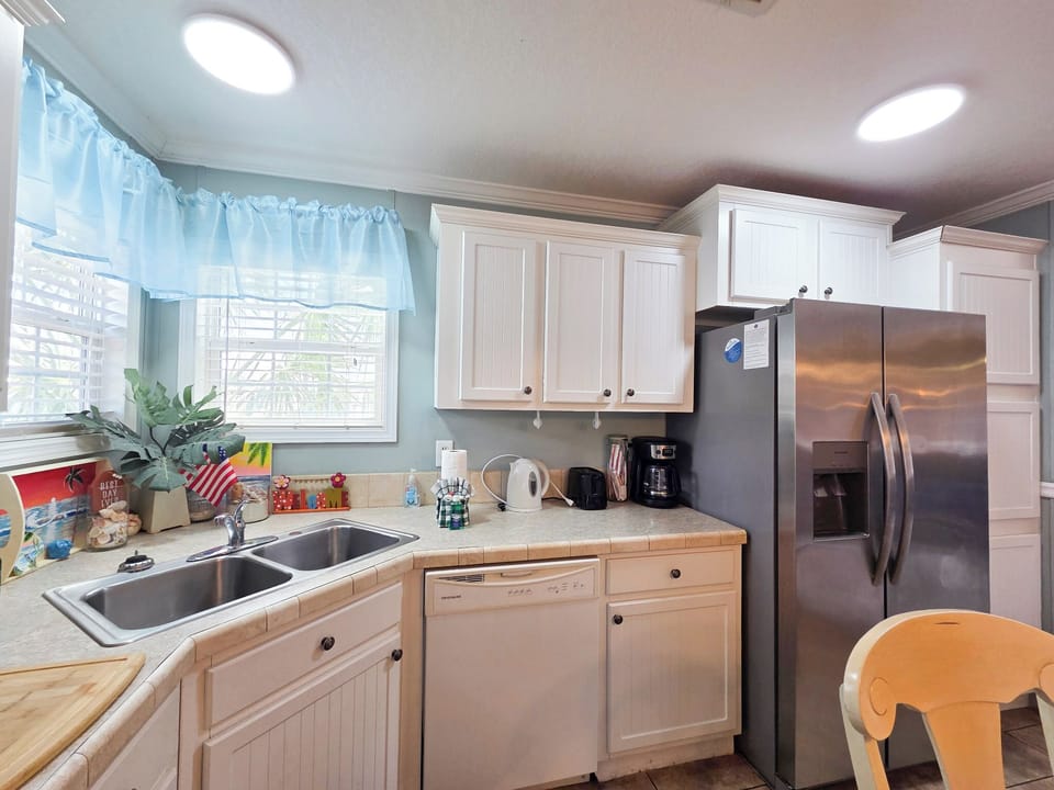 Full kitchen with glass top stove and oven, dishwasher and more.