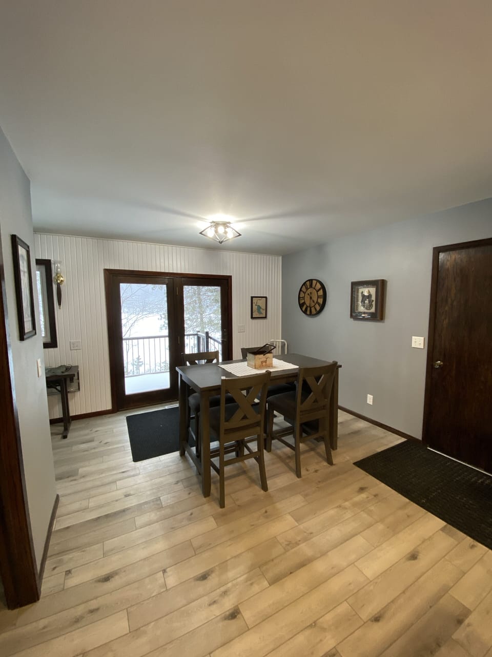 Dining area overlooks the deck and waterfront through patio doors.