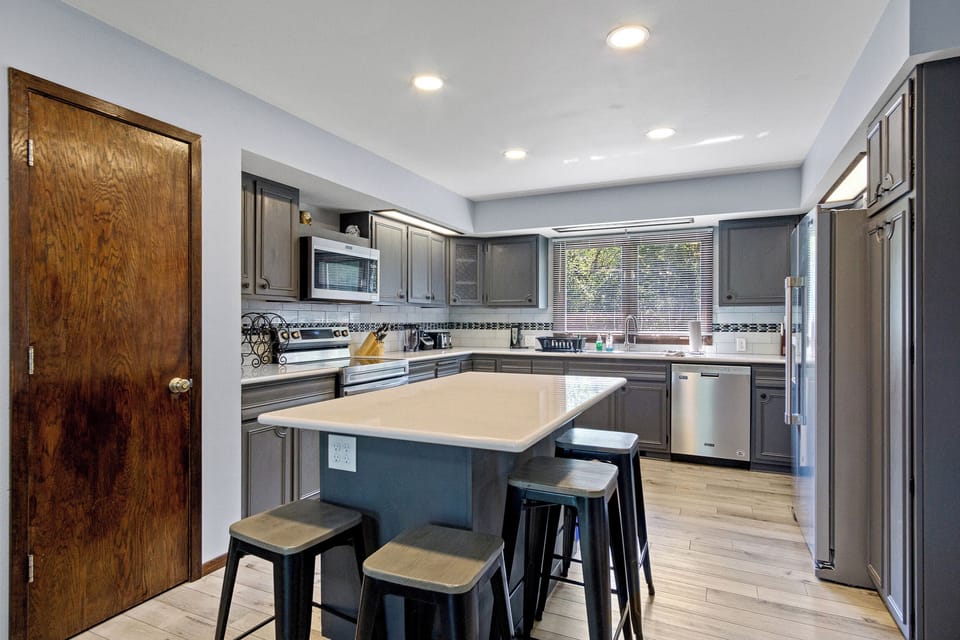Full kitchen with new appliances, a large island and seating for 4.