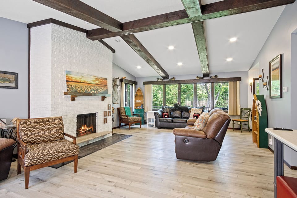 Beautiful living room with wood burning fire place and views of the water.
