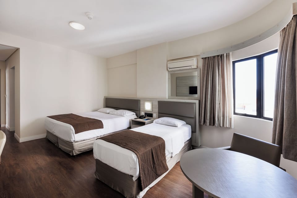 Deluxe Room | Minibar, in-room safe, desk, blackout drapes