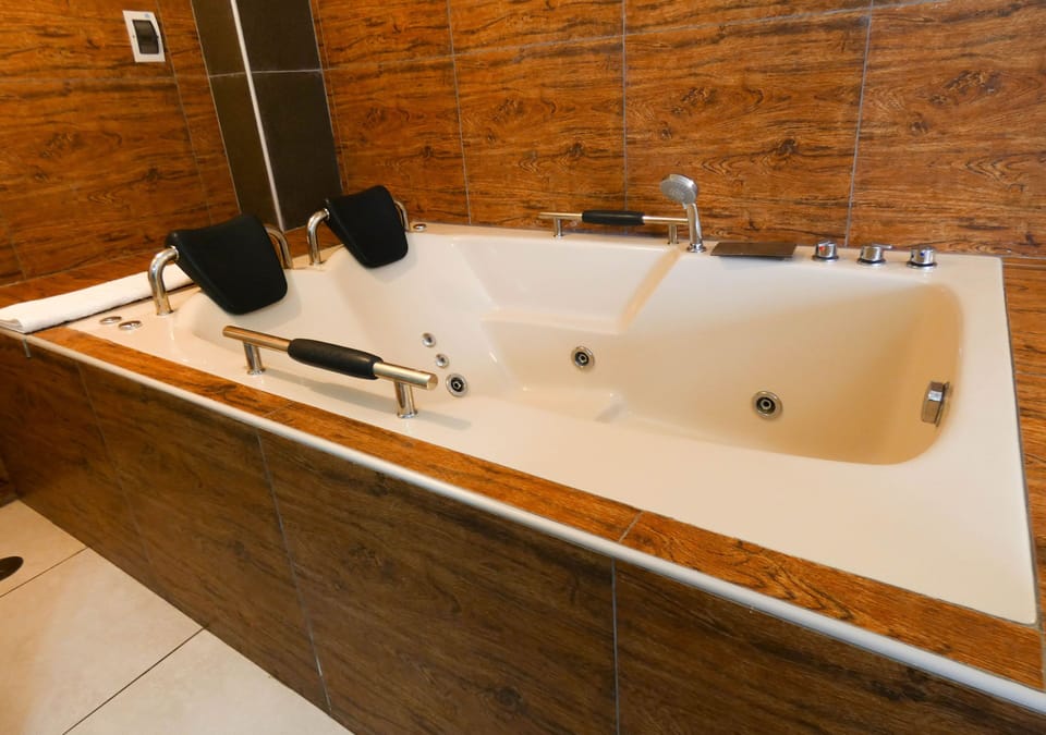 Deluxe Double Room, Hot Tub | Bathroom | Shower, towels, soap, toilet paper