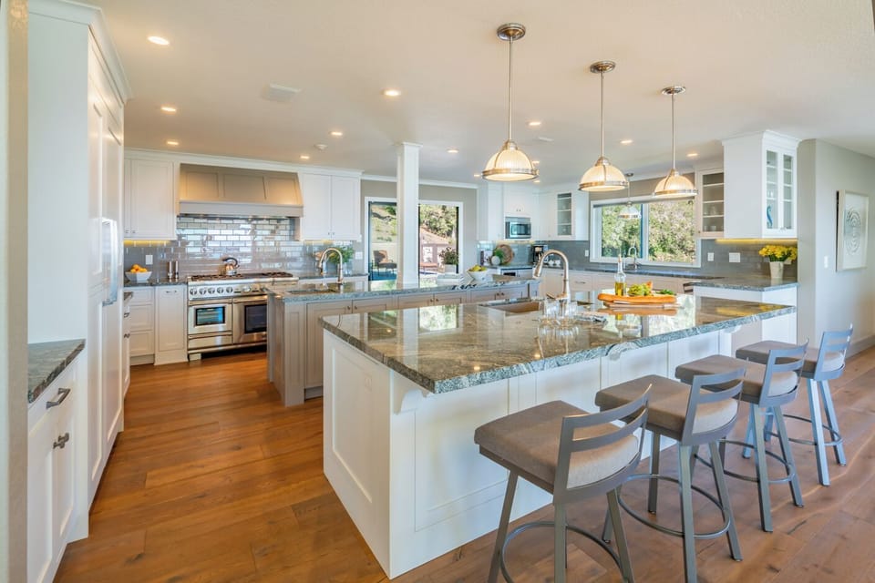 Two kitchen islands and bar stools are great for entertaining