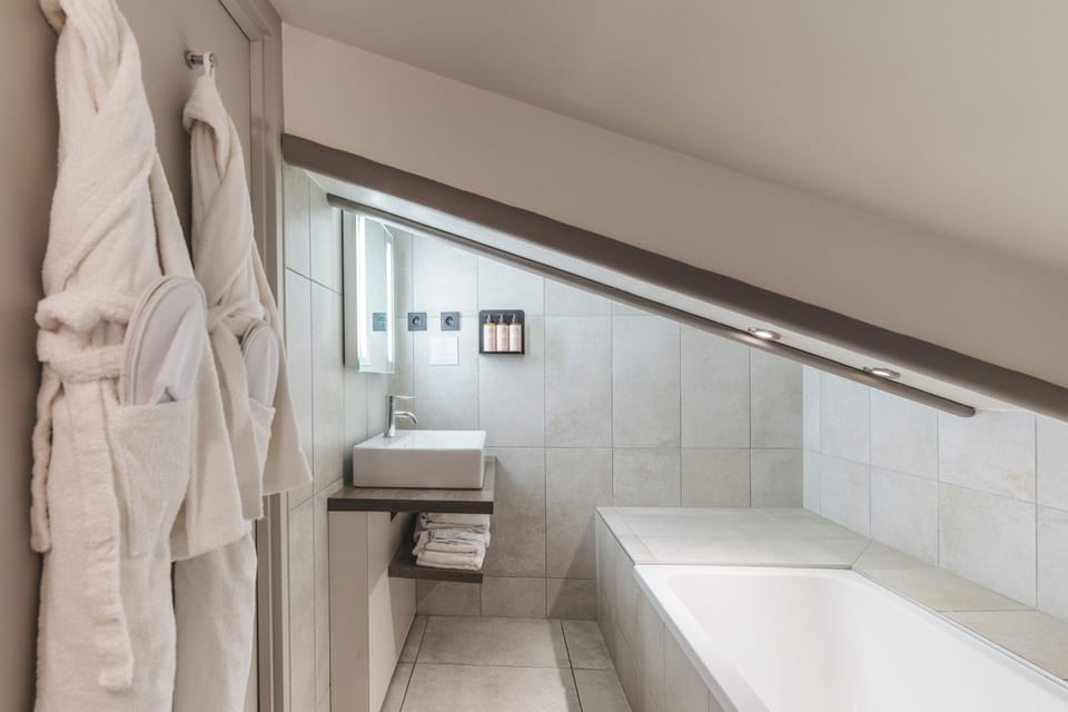 Bathtub, hair dryer, bathrobes, slippers