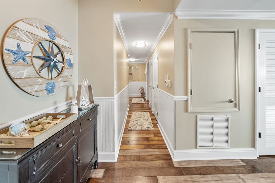 Step into your coastal-inspired hallway where nautical charm meets elegant comfort. Warm hardwood floors and charming beadboard wainscoting guide you home.