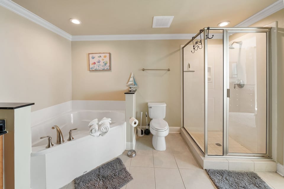 Your private bathroom features a luxurious soaking tub and spacious glass shower, creating your perfect retreat for relaxation.