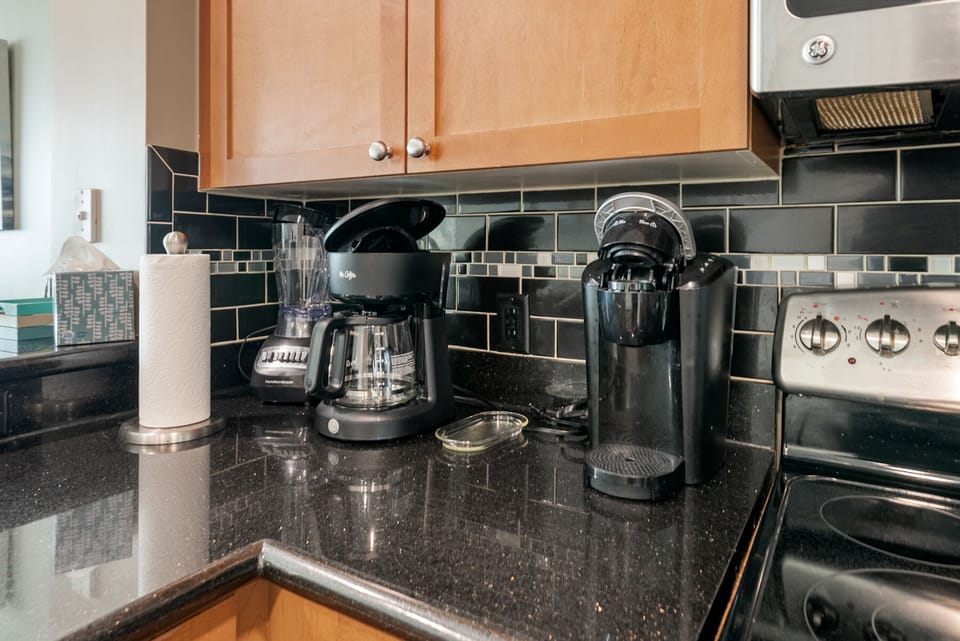 Start your morning right with premium coffee makers ready for your perfect cup in this sleek kitchen.