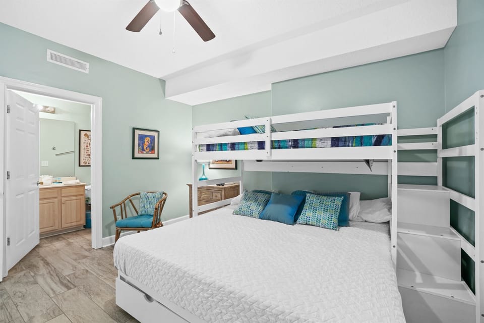 Your coastal bedroom features ocean-inspired decor, bunk beds for extra guests, and beautiful mint walls that create a serene beachside retreat.