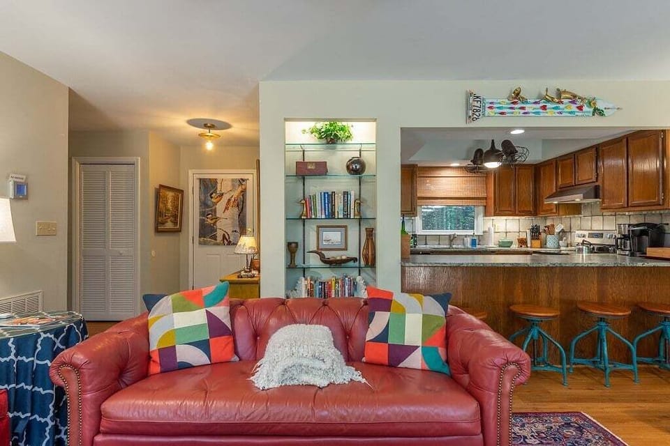 Bookshelf behind the couch that adds more eye catching detail in this condo.