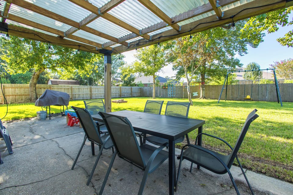 Covered patio with view over the yard and charcoal grill