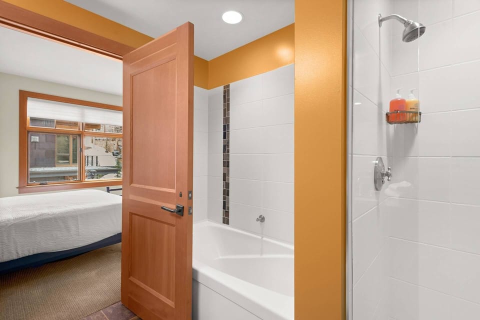 The master bedroom has a spacious en-suite bath with a separate tub and shower.