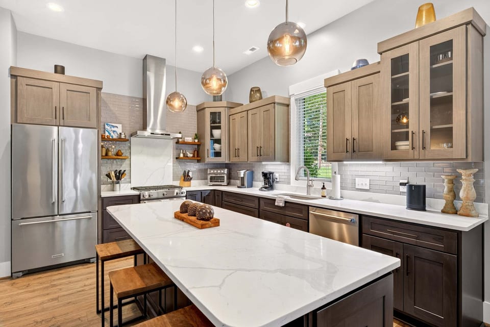 Gourmet kitchen with island seating for 4, gas range stove, Keurig coffeemaker & Sonos Sound System.