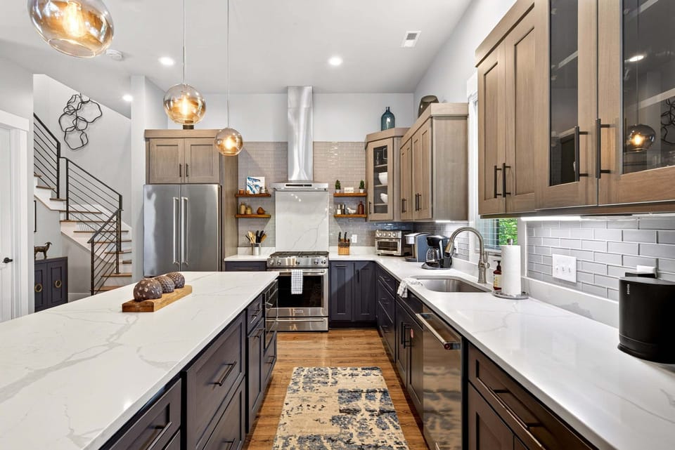 Gourmet kitchen with island seating for 4, gas range stove, Keurig coffeemaker & Sonos Sound System.