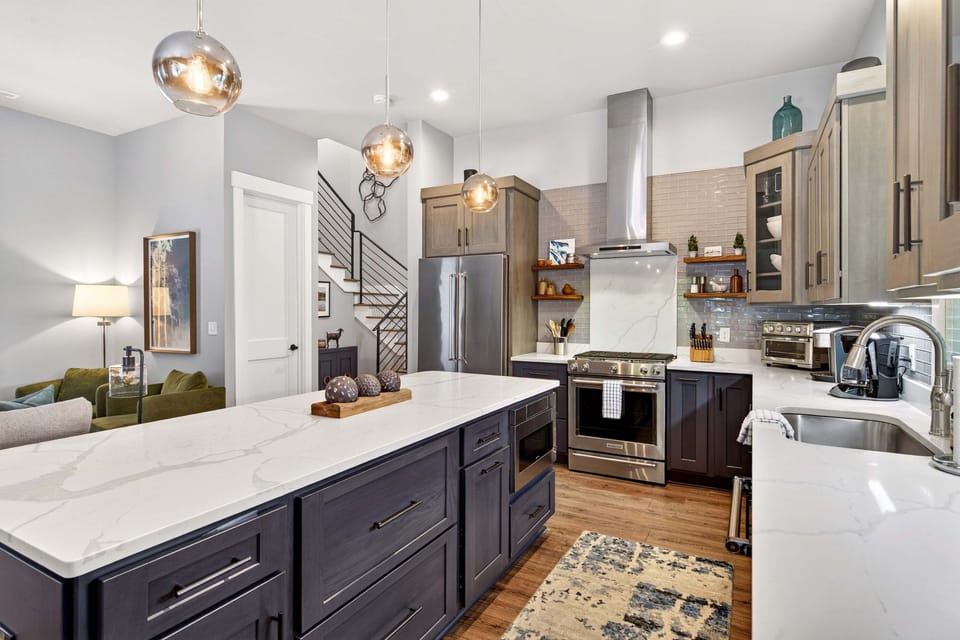 Gourmet kitchen with island seating for 4, gas range stove, Keurig coffeemaker & Sonos Sound System.