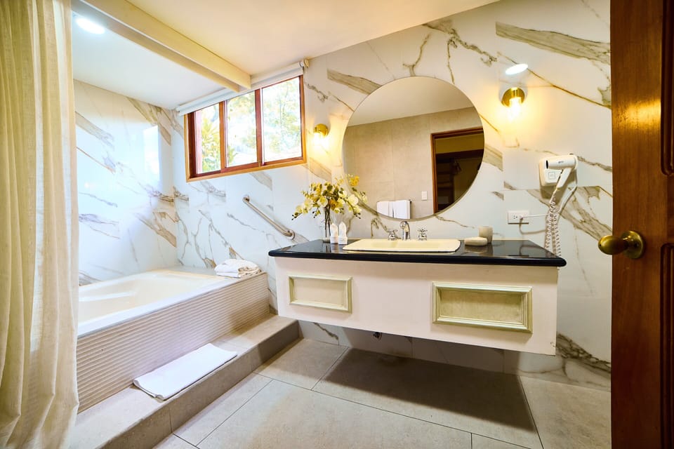 Suite, 1 King Bed | Bathroom | Hair dryer, towels