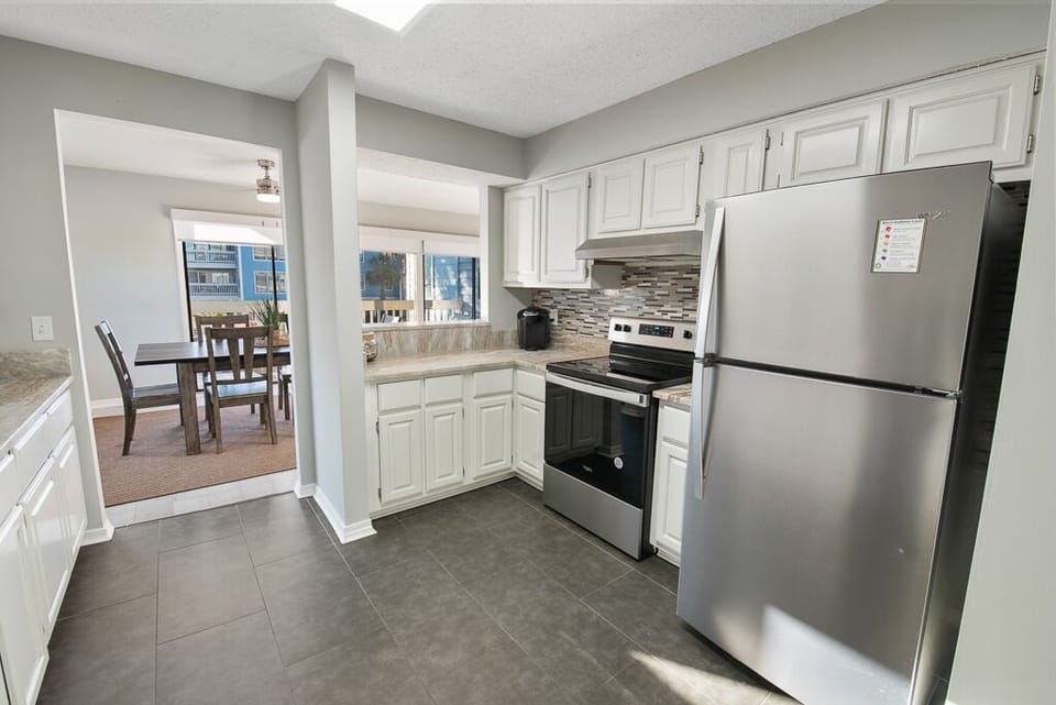 Condo, 3 Bedrooms, Balcony, Pool View (Pet Friendly – B105) | Private kitchen | Full-size fridge, microwave, oven, stovetop