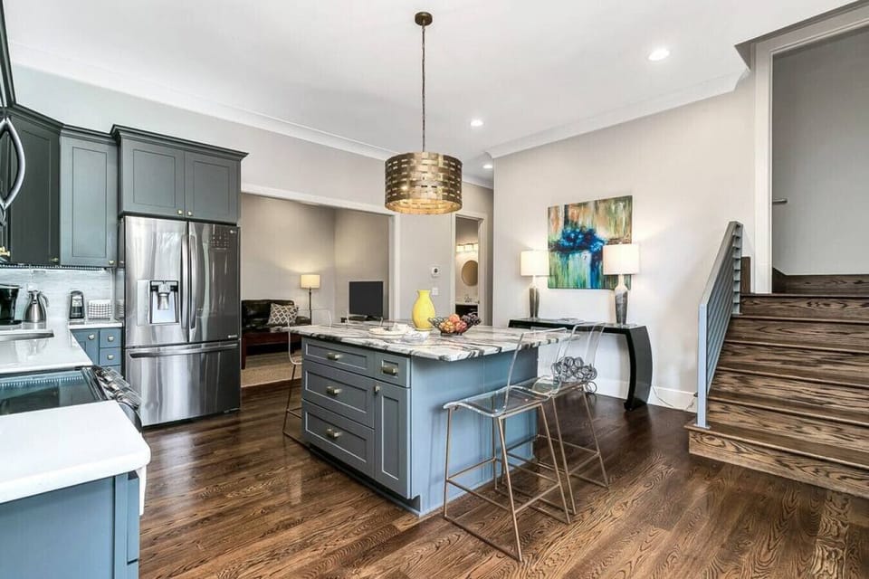 The lower level features a second full living space, complete with kitchen, two king bedrooms, one queen bedroom, two three-quarter baths, one half bath, plus access to the hot tub, backyard, and garage/game-room!