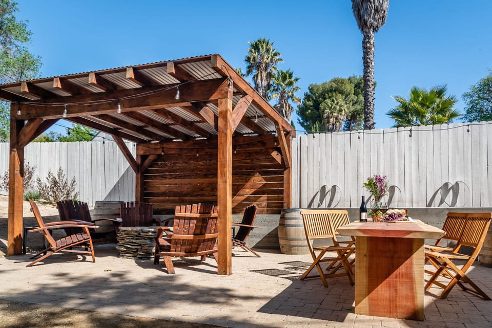 Private backyard pergola with lounge seating.