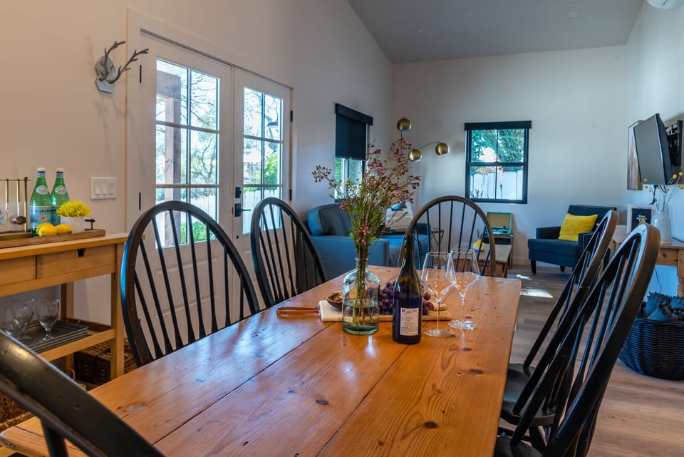 French doors and a long dining table give this shared space an easy indoor-outdoor feel