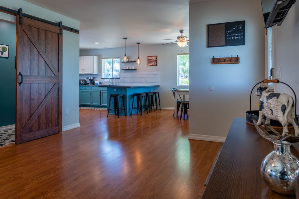 Entry area with half bath off to the side, leading to the kitche