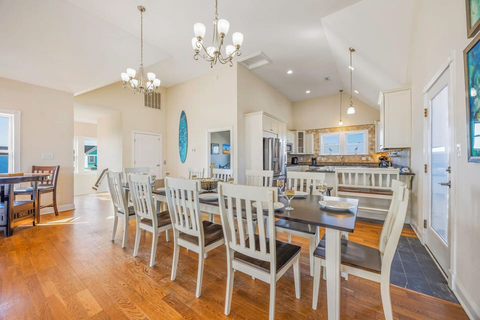 Your spacious open-concept kitchen and dining area features elegant chandeliers, modern appliances, and seating for memorable family meals together.