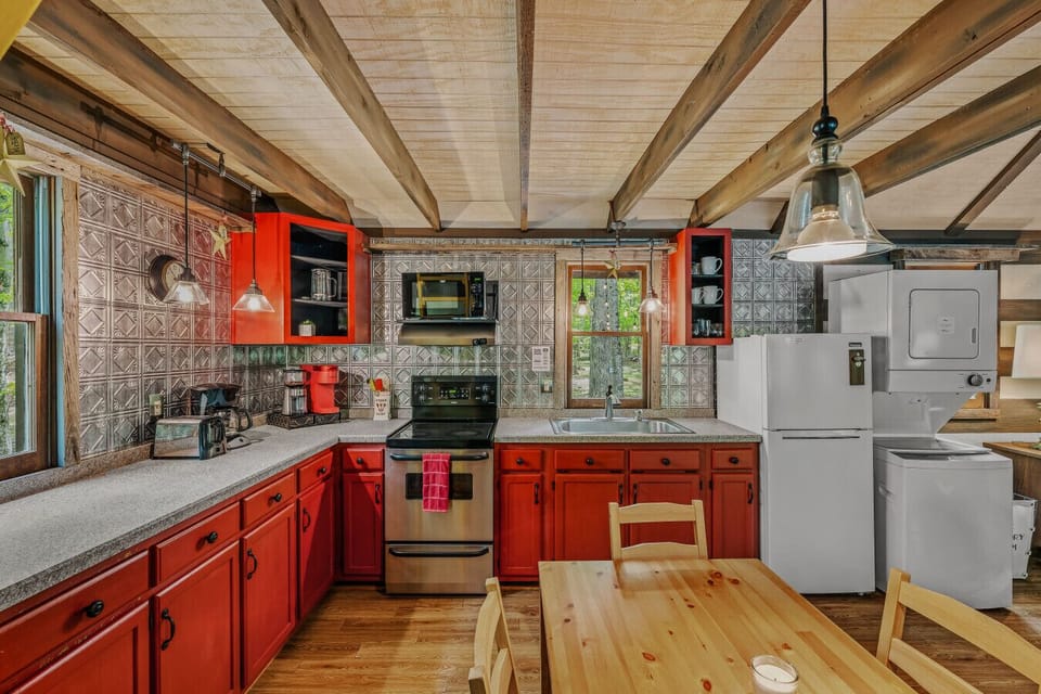 Full kitchen with range and stacked washer and dryer!