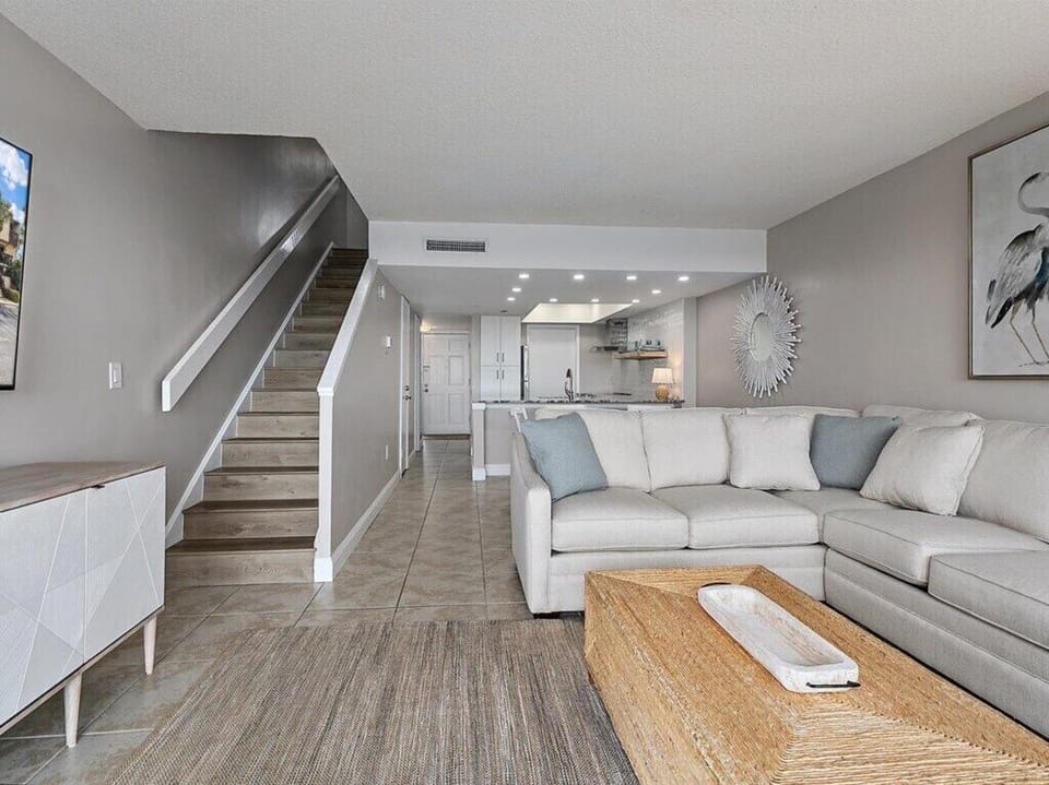 Elegant open-plan living room with plush seating and tasteful decor.