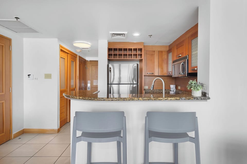 The kitchen has 2 stools to enjoy your meals.