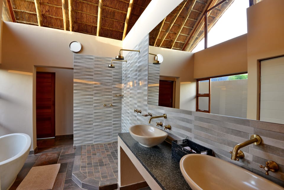 Luxury Suite, 1 King Bed, Hot Tub | Bathroom | Separate tub and shower, rainfall showerhead, free toiletries