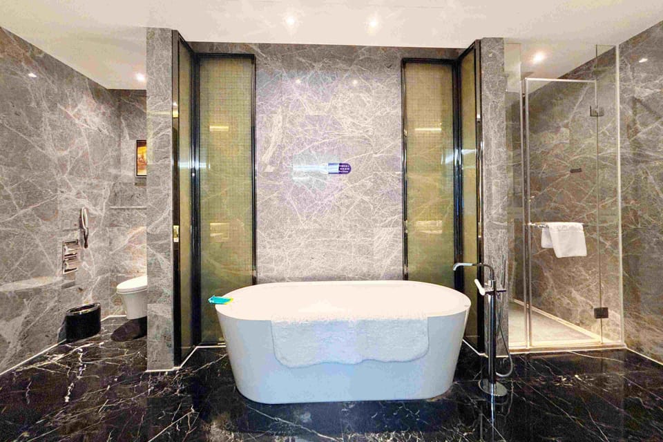 Executive Suite, 1 King Bed | Bathroom | Designer toiletries, hair dryer, bathrobes, slippers