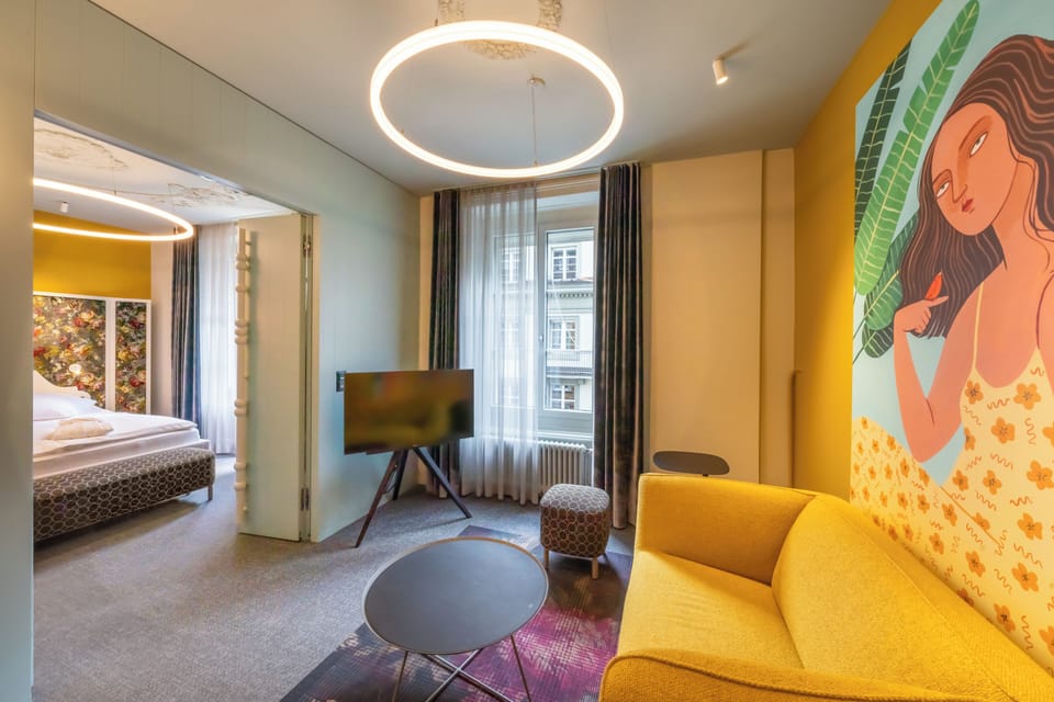 BOUTIQUE Suite with balcony | Living area | 22-inch flat-screen TV with satellite channels, TV, heated floors