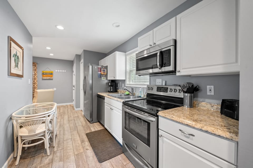 Fully equipped kitchen with stainless steel appliances.