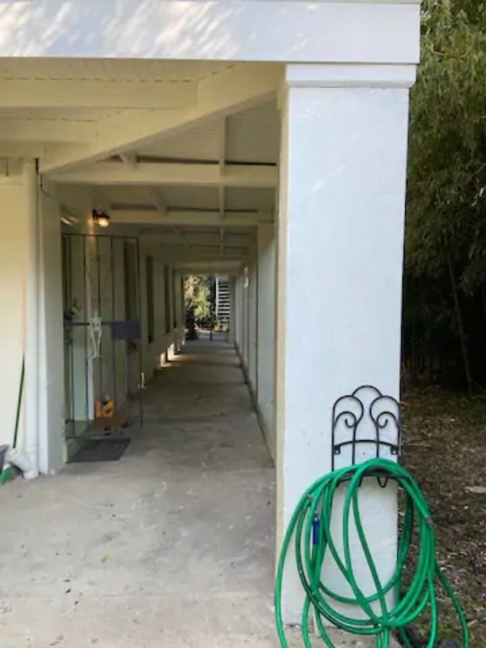 Once you've entered the property, continue down the hallway past the main house.
