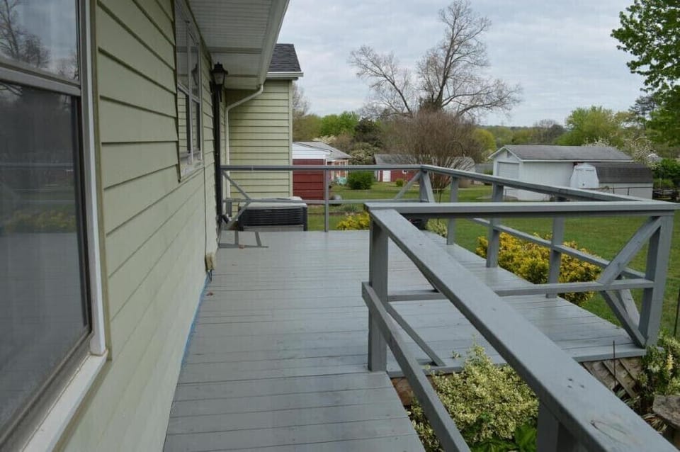 Nice back deck with a pair of Adirondack chairs and grill (not pictured)