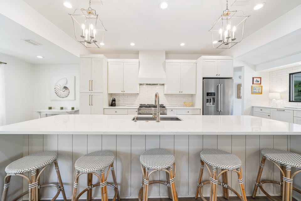 Open Kitchen with gas range, ample counterspace + seating.  Desk area to left