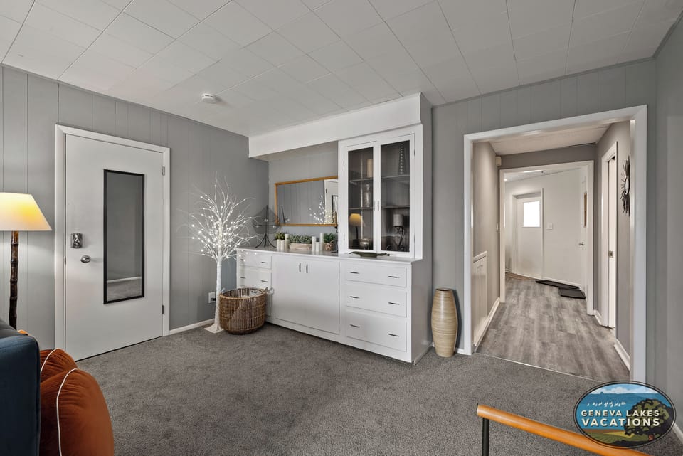 Large living room area with hallway to full bath and kitchen